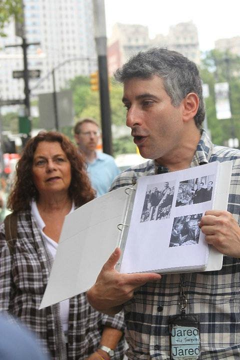 Jared Goldstein showing a group historical photos on a New York City street tour