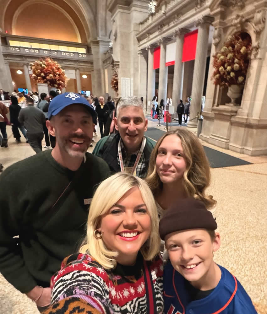 A family taking a selfie with Jared in the Great Hall of the Metropolitan Museum