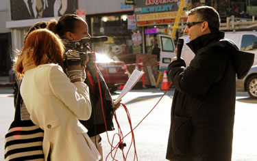 Jared being interviewed on camera on a Harlem street