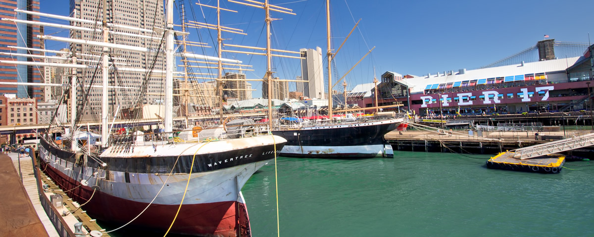 Tall ships docked at the South Street Seaport with Pier 17 in the background