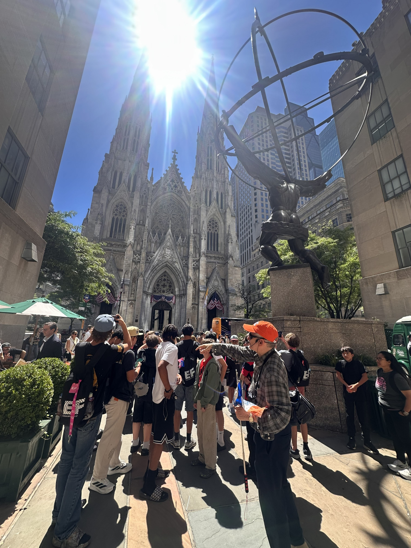 Jared leading a group in front of St. Patrick's Cathedral and the Atlas statue at Rockefeller Center