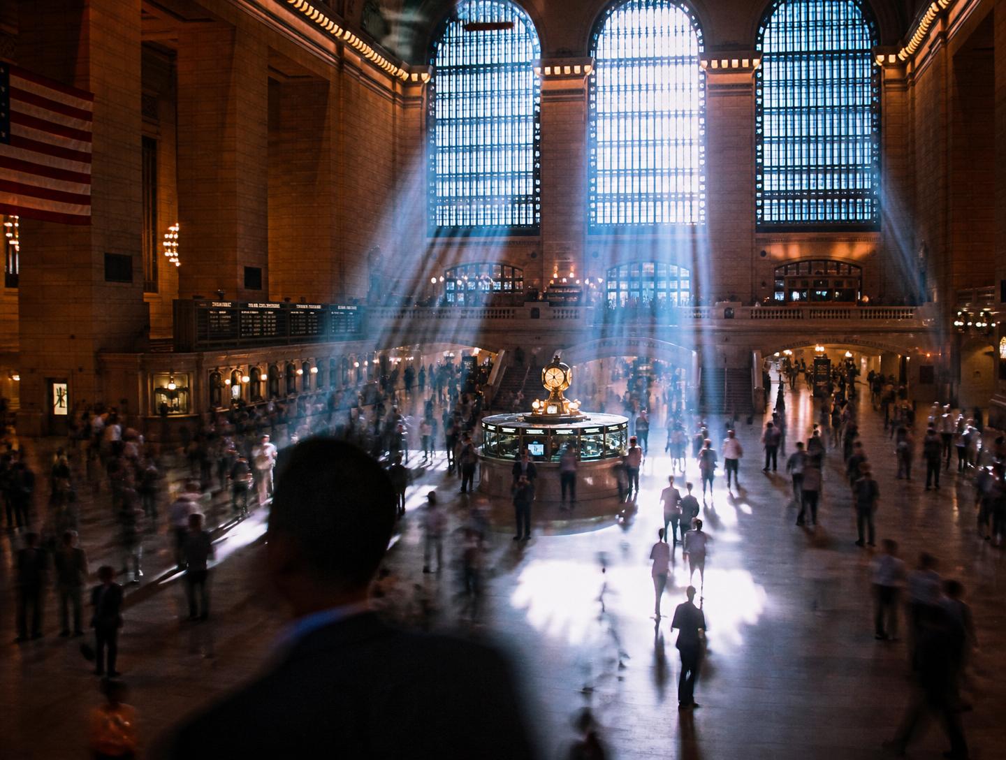 Grand Central Terminal main hall with beams of light and commuters in motion blur